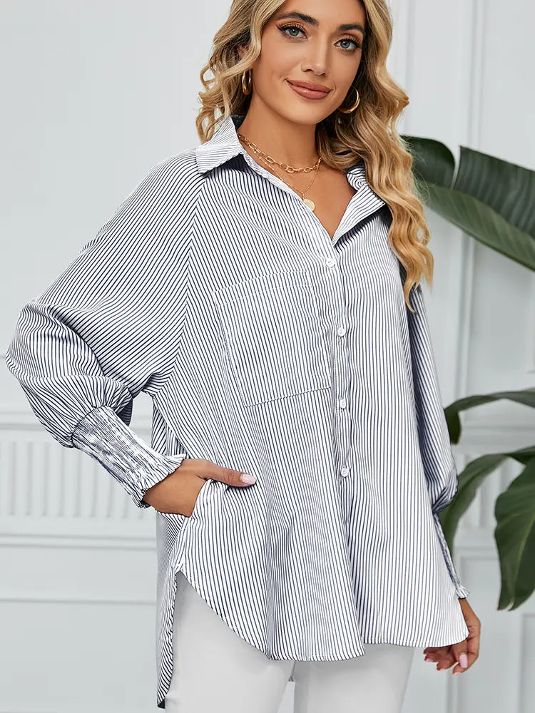 Front view of striped loose-fit shirt with pleated cuffs