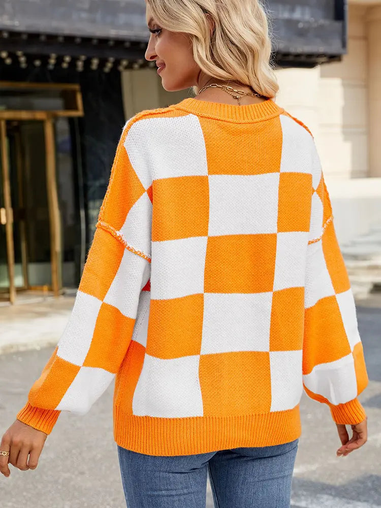Back view of plaid orange and white pullover sweater