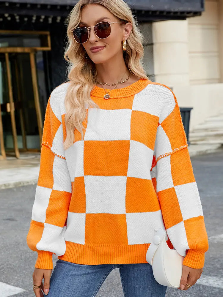 Front view of plaid orange and white pullover sweater