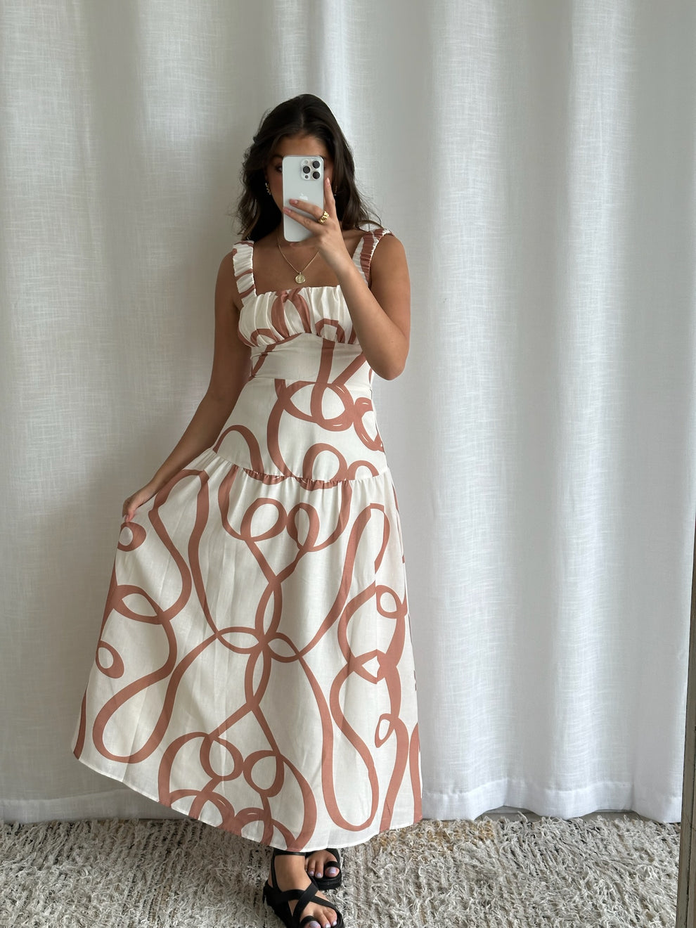 Side view of patterned maxi dress with shoulder detail